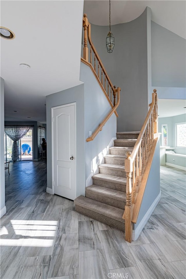 stairway with hardwood / wood-style floors