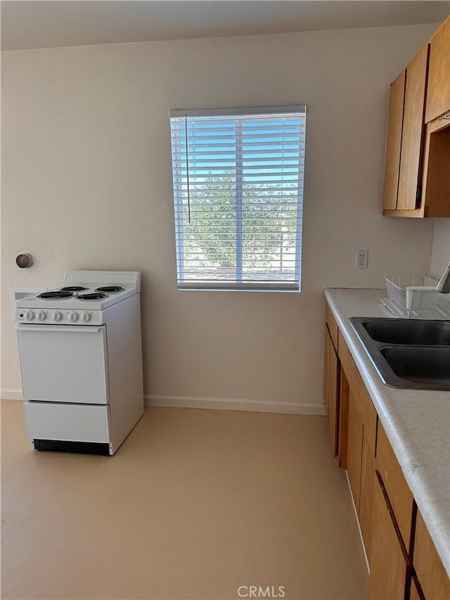 kitchen featuring white range with electric stovetop and sink