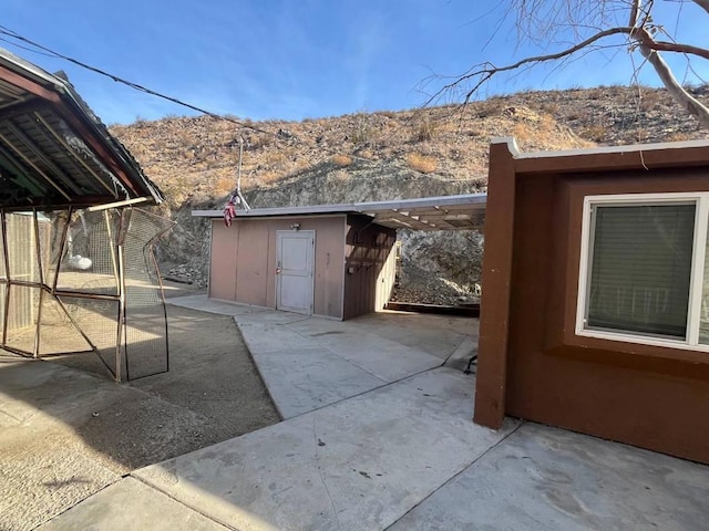 view of patio with a storage shed