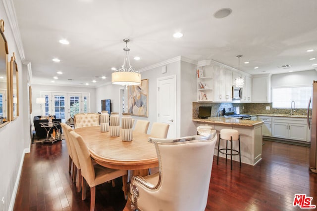 dining room featuring crown molding, dark hardwood / wood-style flooring, sink, and french doors