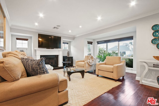 living room with a wealth of natural light, dark wood-type flooring, and ornamental molding