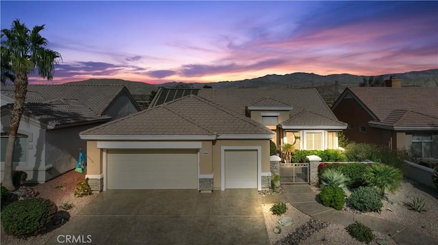 view of front of house featuring a mountain view and a garage