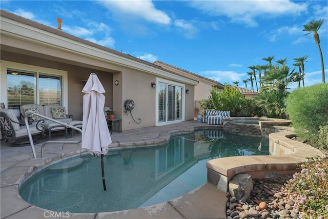 view of pool with an in ground hot tub, an outdoor living space, and a patio