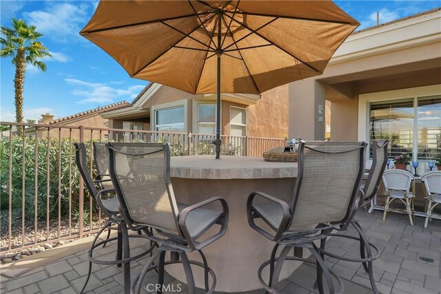 view of patio with an outdoor bar