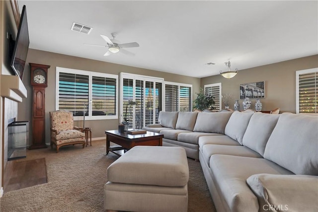 living room featuring carpet floors and ceiling fan