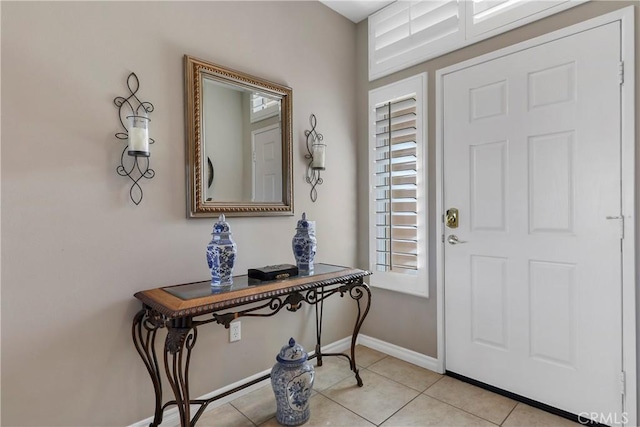 foyer featuring a wealth of natural light and light tile patterned flooring