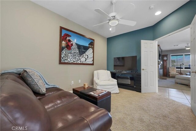 carpeted living room featuring ceiling fan and lofted ceiling