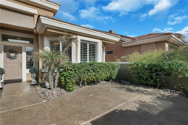 property entrance featuring a patio