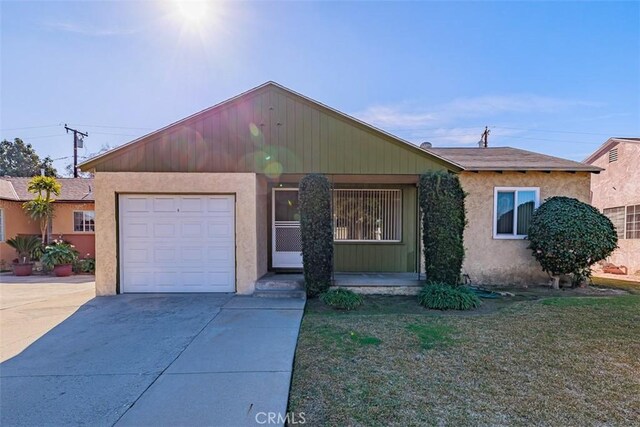 ranch-style house with a garage and a front yard