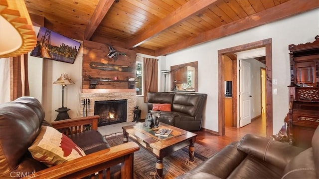 living room with a fireplace, wooden ceiling, beam ceiling, and hardwood / wood-style floors