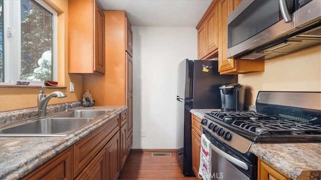 kitchen with dark wood-type flooring, sink, and stainless steel appliances