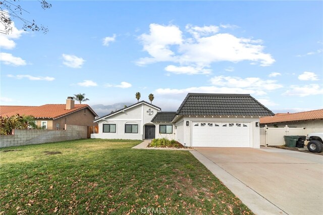 view of front of home featuring a front yard and a garage