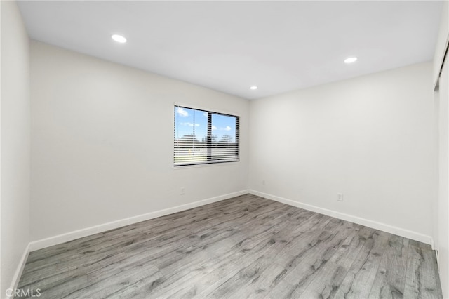 spare room with light hardwood / wood-style flooring