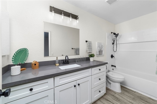 full bathroom featuring hardwood / wood-style flooring, toilet, vanity, and bathing tub / shower combination