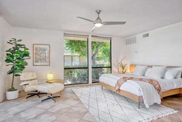 bedroom with expansive windows and ceiling fan