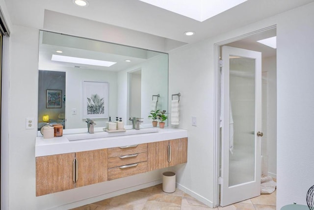 bathroom with vanity and a skylight