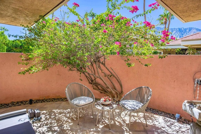 view of patio / terrace featuring a mountain view