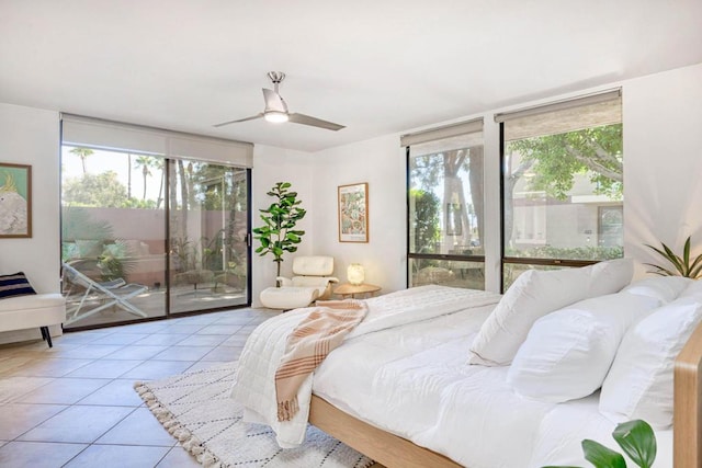 bedroom featuring multiple windows, light tile patterned flooring, access to outside, and ceiling fan