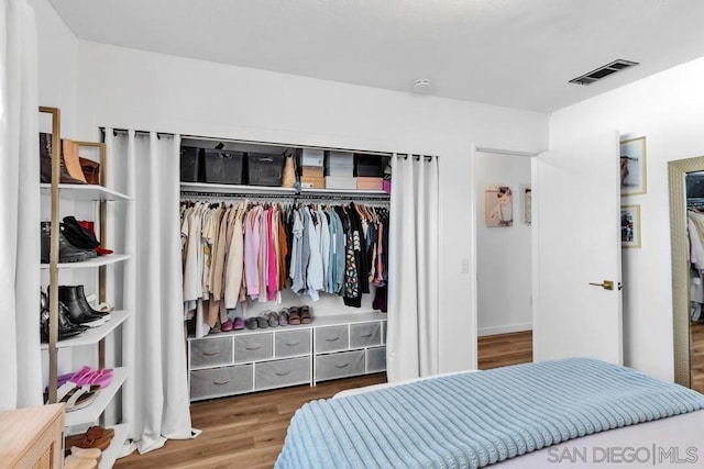 bedroom with hardwood / wood-style flooring and a closet