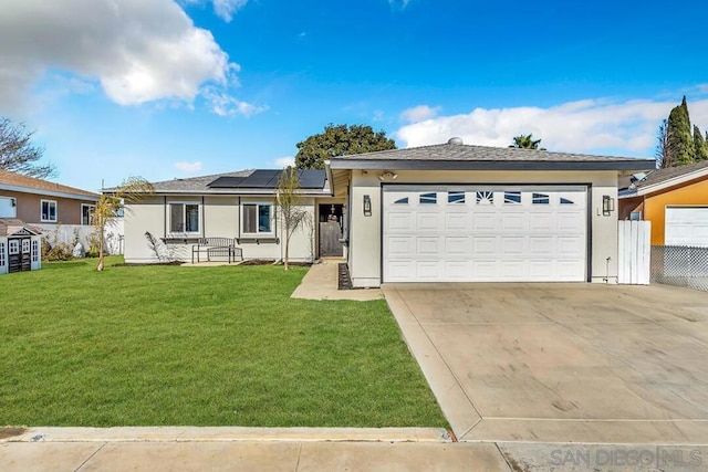 ranch-style home featuring a front lawn, a garage, and solar panels