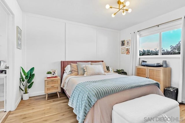 bedroom featuring a chandelier and hardwood / wood-style floors