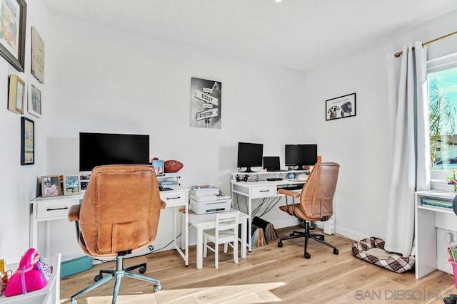 office space with light wood-type flooring