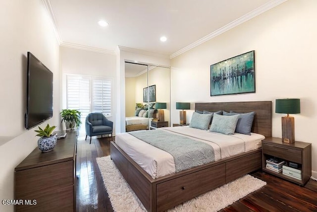 bedroom with crown molding, dark hardwood / wood-style flooring, and a closet