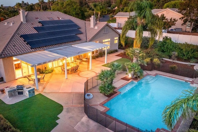 view of swimming pool featuring a patio area and exterior bar