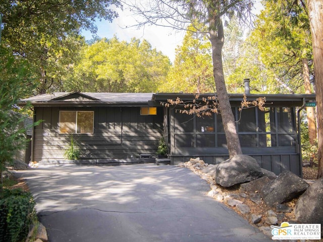 view of front of house featuring a sunroom