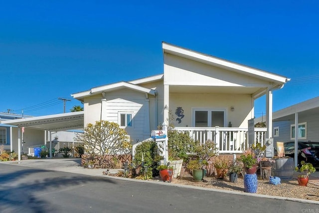 view of front of house featuring a carport and covered porch