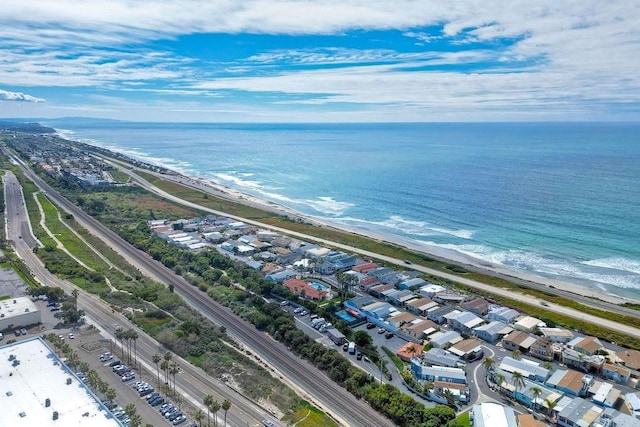 drone / aerial view featuring a water view and a beach view