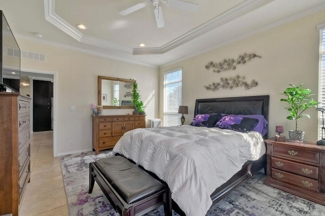 bedroom featuring light tile patterned floors, crown molding, a raised ceiling, and ceiling fan