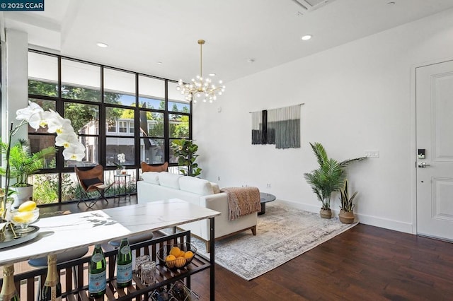 living room featuring expansive windows, dark hardwood / wood-style flooring, and a chandelier