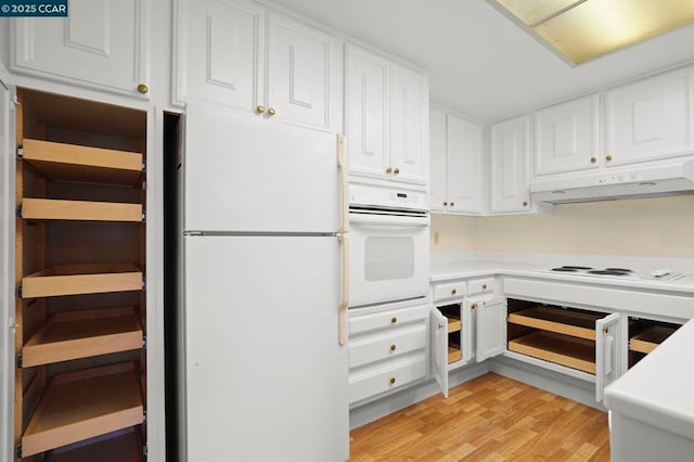 kitchen with white appliances, light hardwood / wood-style floors, and white cabinets