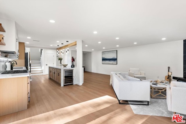 living room featuring beverage cooler and light wood-type flooring