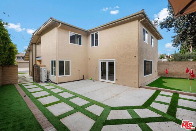 rear view of house featuring a patio area and french doors