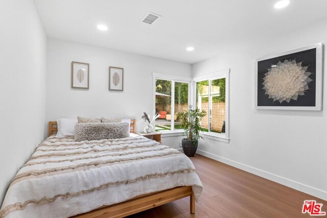 bedroom with wood-type flooring