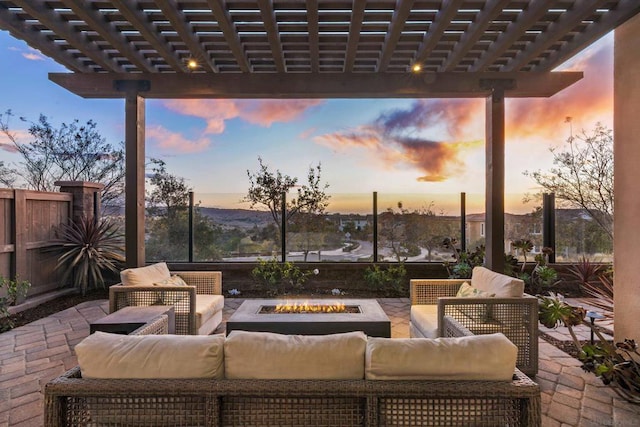 patio terrace at dusk with a pergola and an outdoor living space with a fire pit