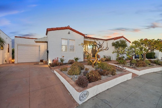 mediterranean / spanish-style home with a garage