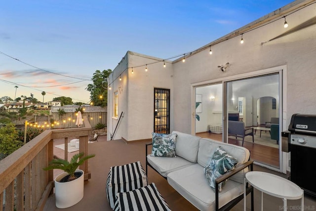 patio terrace at dusk featuring outdoor lounge area and grilling area