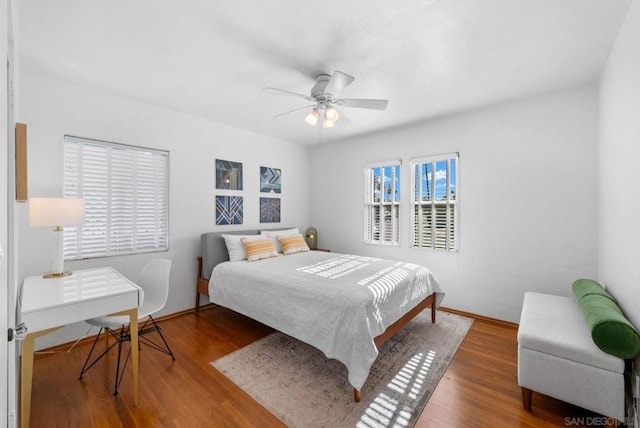 bedroom with ceiling fan and wood-type flooring