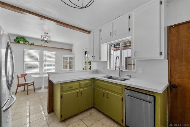 kitchen with green cabinets, appliances with stainless steel finishes, plenty of natural light, and sink