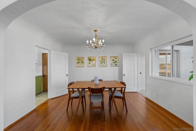 dining space featuring a chandelier and hardwood / wood-style floors