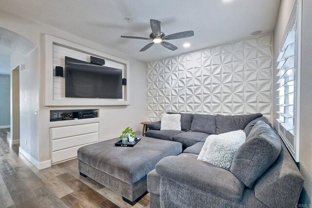 living room featuring ceiling fan and hardwood / wood-style flooring