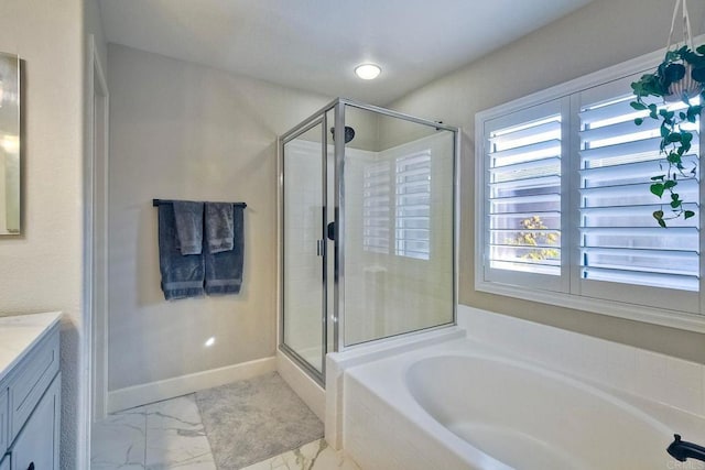 bathroom featuring vanity and independent shower and bath