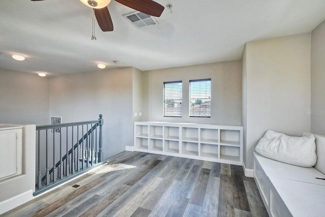 interior space featuring wood-type flooring and ceiling fan