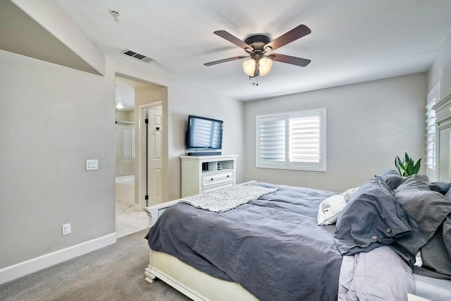 bedroom with ceiling fan, ensuite bathroom, and light carpet