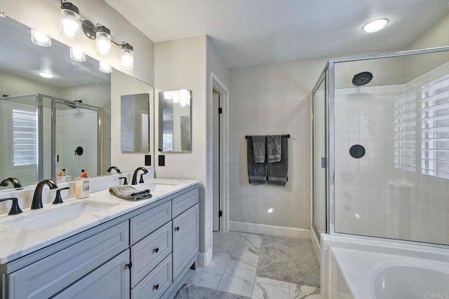 bathroom featuring vanity and independent shower and bath