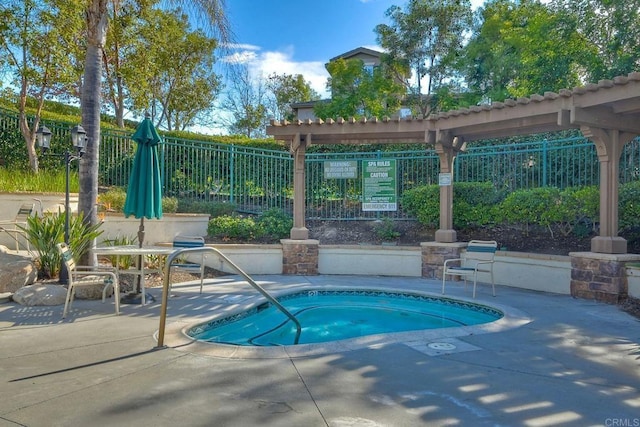 view of pool featuring a pergola, a community hot tub, and a patio