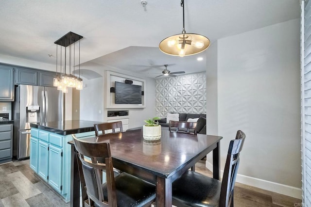 dining space with wood-type flooring and ceiling fan